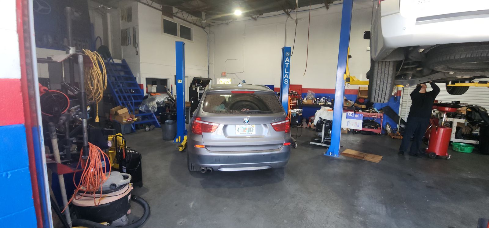 Two-post lifts with a BMW in the service bay
