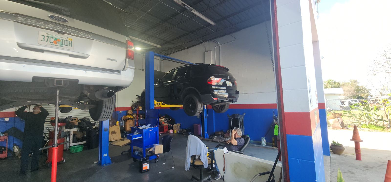 Vehicles raised on lifts in the shop bays
